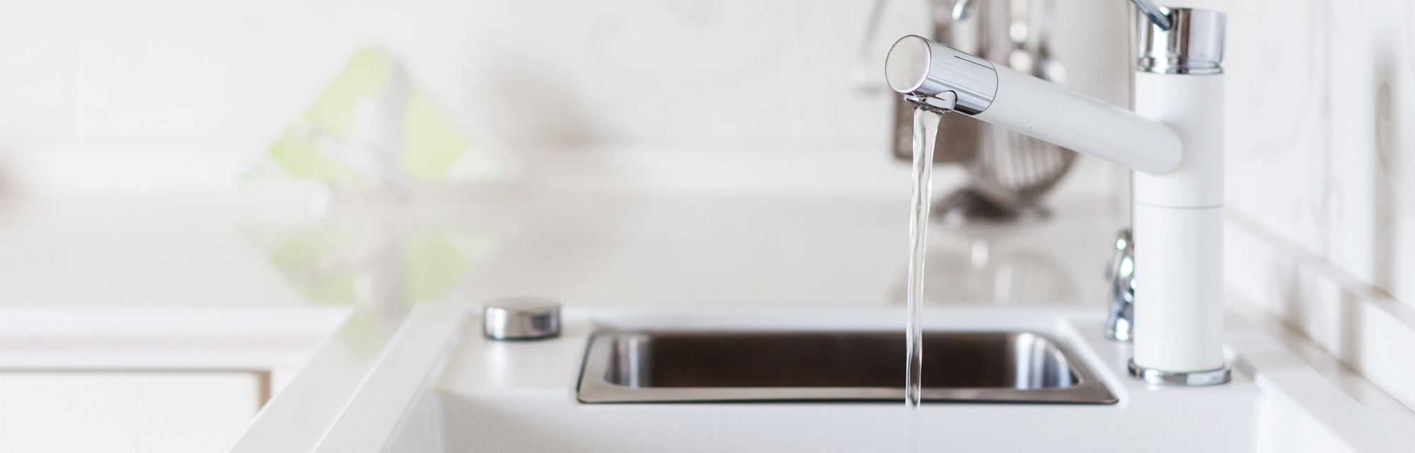 Modern Designer Chrome Water Tap Over White Kitchen Sink