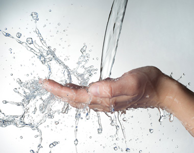 Human Hands With Water Splashing On Them